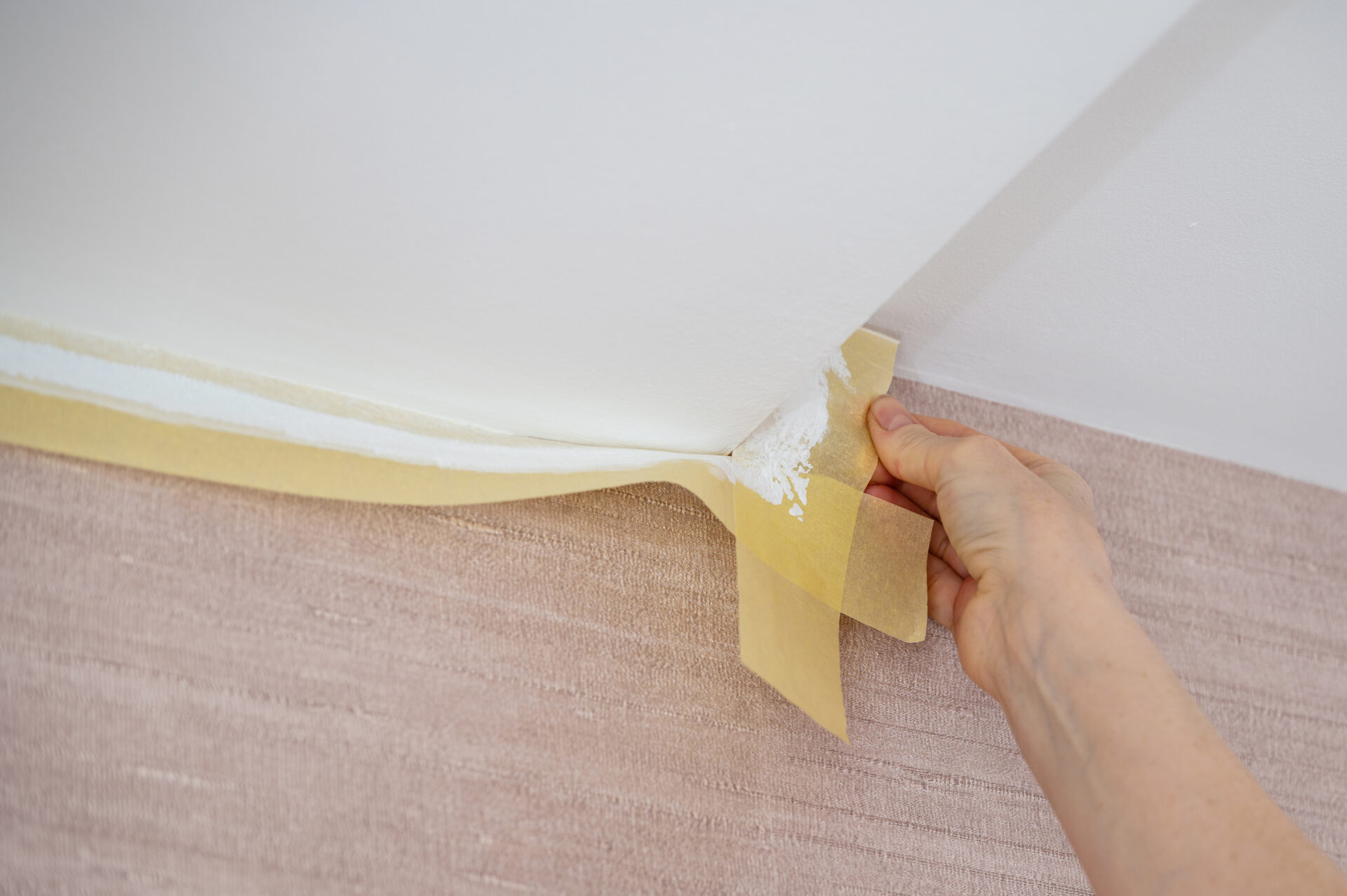 close up of female hands remove masking tape