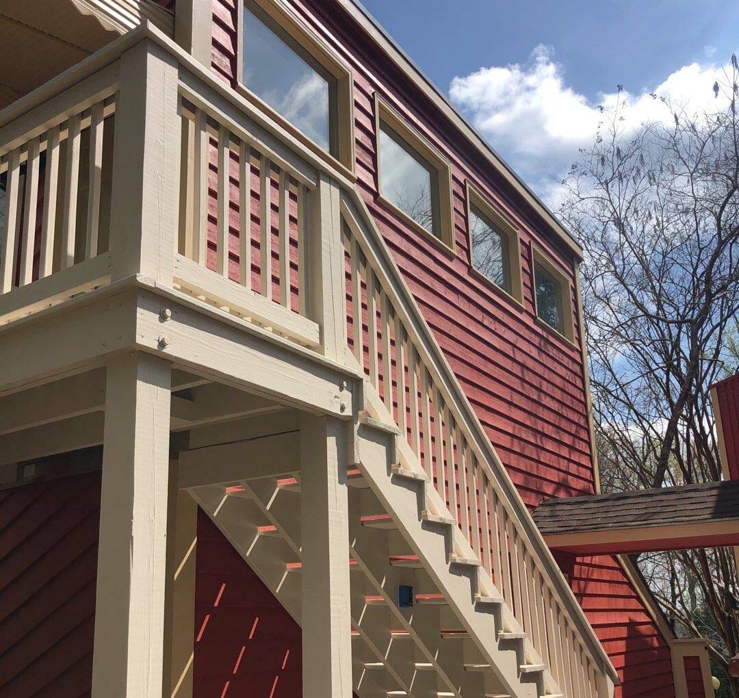 red house with white stairs