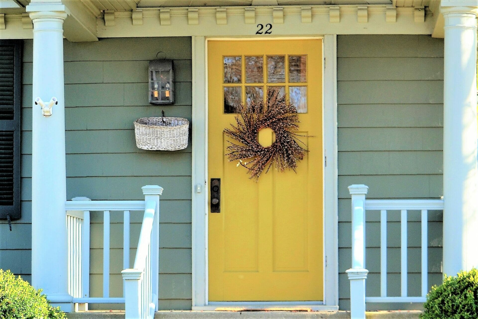 welcoming front door entrance painted a bright yellow