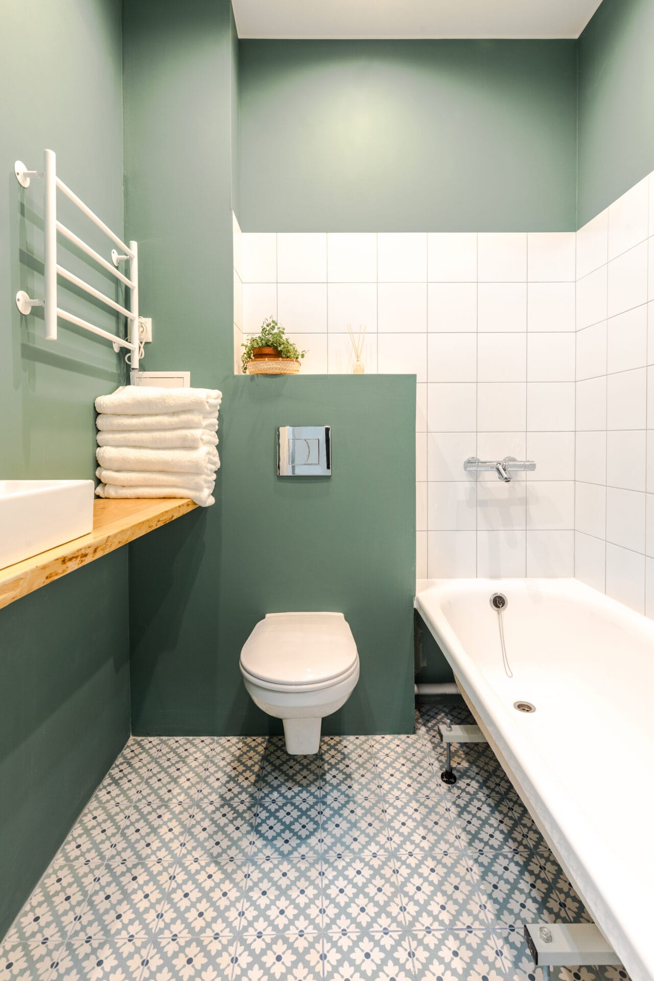 minimalistic elegant design of bathroom in wormwood green color, installation, white bath. wall paint for wet room using minimalistic elegant design of bathroom in wormwood green color, installation, white bath. wall paint for wet room using