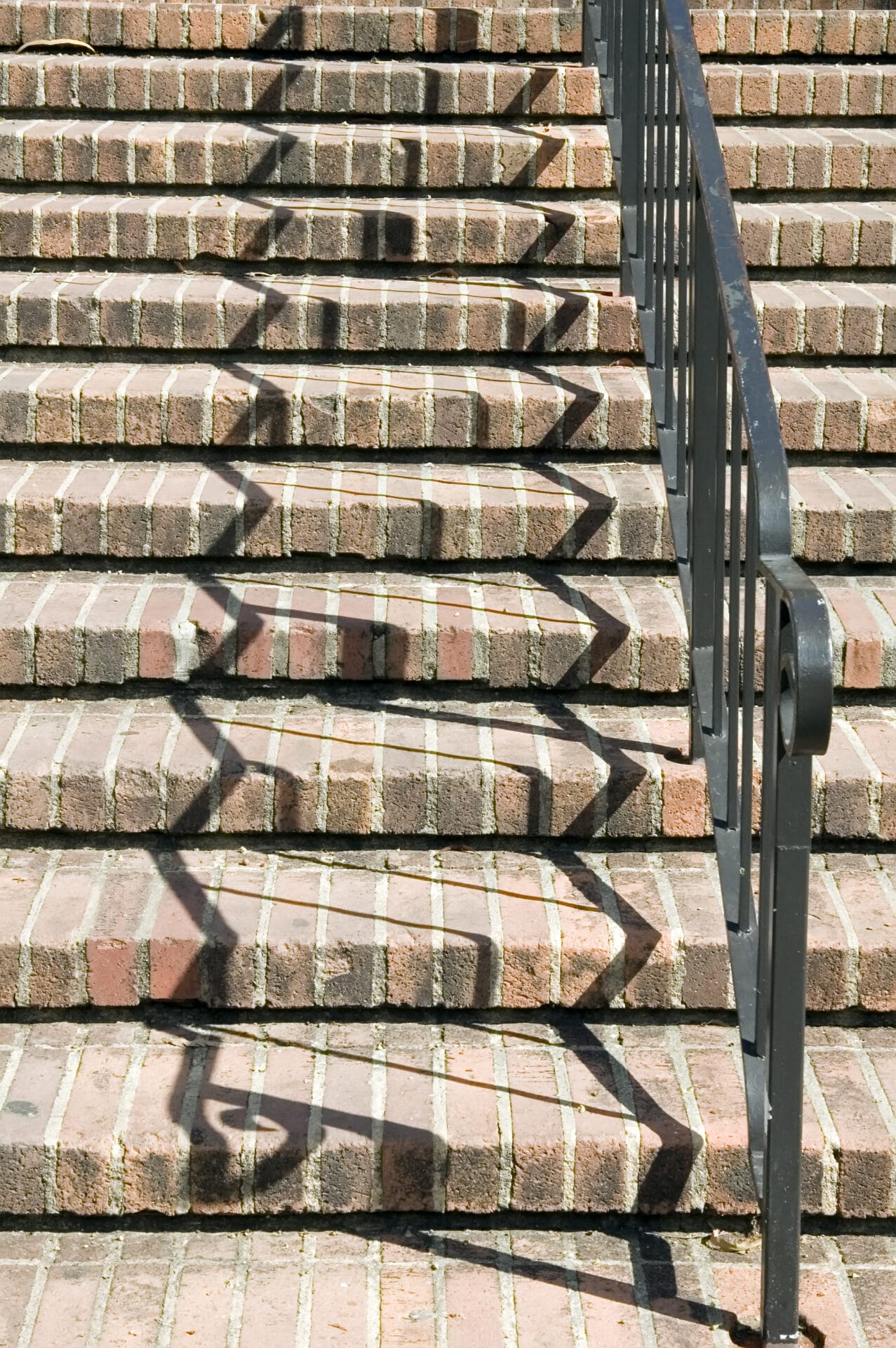zigzag shadows of black handrail on red brick stai 2026 01 09 14 34 23 utc zigzag shadows of black handrail on red brick stai 2026 01 09 14 34 23 utc
