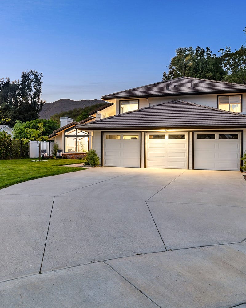 a two story house with a three car garage